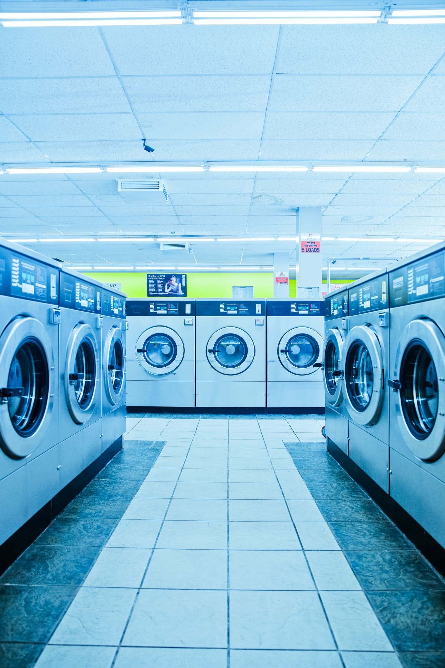 Bright rows of washing machines inside a neighborhood laundromat