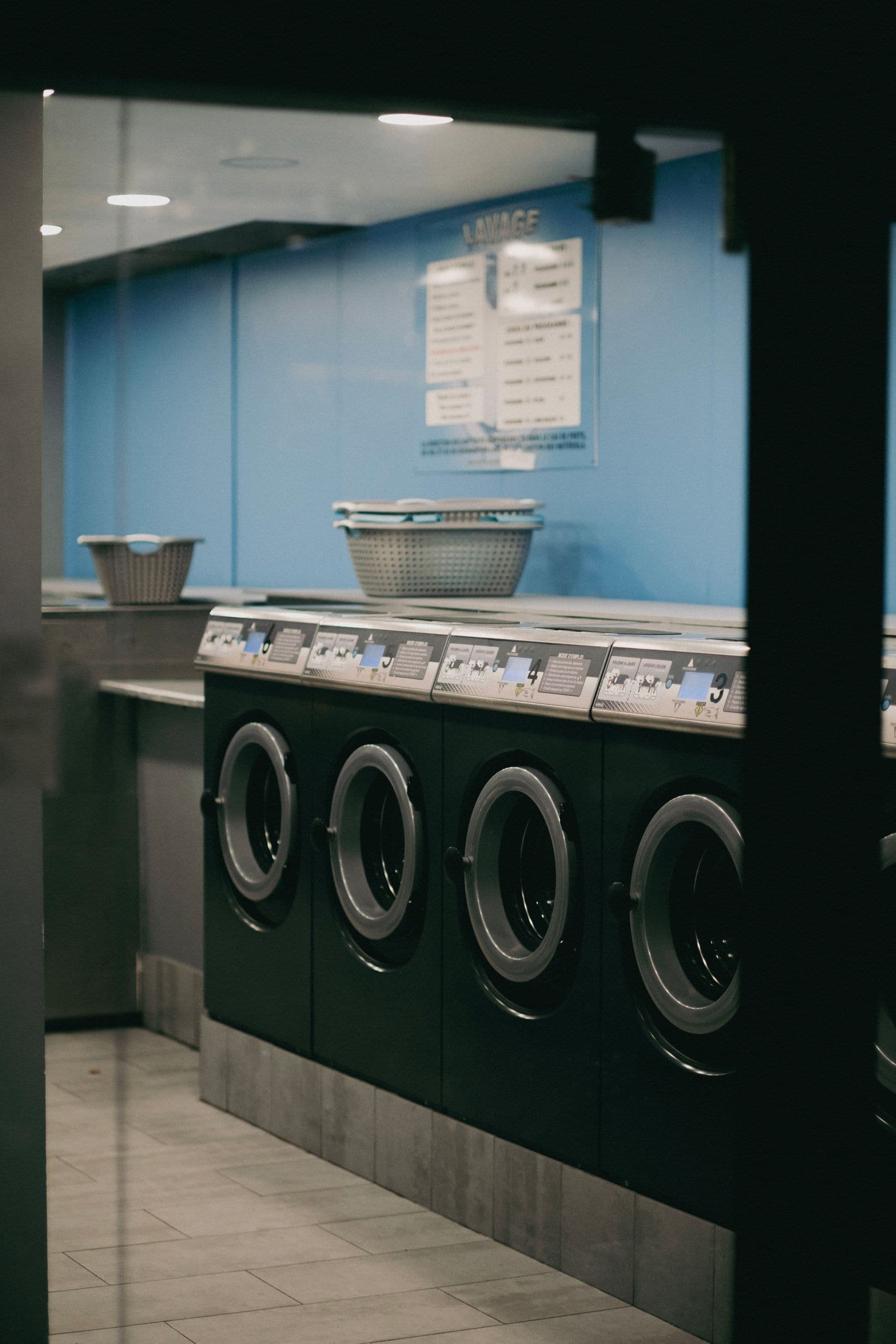 Rows of washers inside a working laundromat